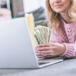 Cropped View Of Cheerful Woman Holding Dollar Banknotes